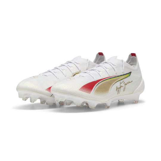 PUMA Ultra 5 Ultimate Senna Gazon Naturel Chaussures de Foot (FG) Blanc Doré Rouge